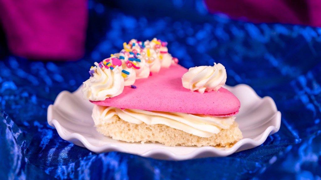 Disneyland 70th Anniversary Food, Disneyland Snacks, 70th Celebration Snacks, Disneyland Food Review, Disneyland 70th Anniversary Treats, Café Daisy Chicken Bacon Ranch Flop-Over, 70th Celebration Churro, Jolly Holiday Bakery Café Celebration Matterhorn Macaroon, Market House Mickey Hat Cookie, Red Rose Tavern 70th Stuff, 70th Celebration Macaron, Refreshment Corner Pulled Pork Mac and Cheese in a Bread Bowl, Tiana’s Palace House-filled Celebration Beignet, Troubadour Tavern W.E.D. Chili Cheese Baked Potato, Troubadour Tavern Chicken Pot Pie Baked Potato, Troubadour Tavern Tiramisu Cold Brew, Hollywood Lounge Celebration Cocktail, Hollywood Lounge Pink Dragon Fruit Mimosa, Schmoozies Mickey-shaped Celebration Waffles, Disneyland Celebration Snacks 2023, Disneyland Food Guide, Disneyland Special Drinks, Disneyland Bakery Items, Disneyland Menu Highlights, Disneyland Sweet Treats, Disneyland Savory Snacks, Disneyland Party Foods, Disneyland Anniversary Eats